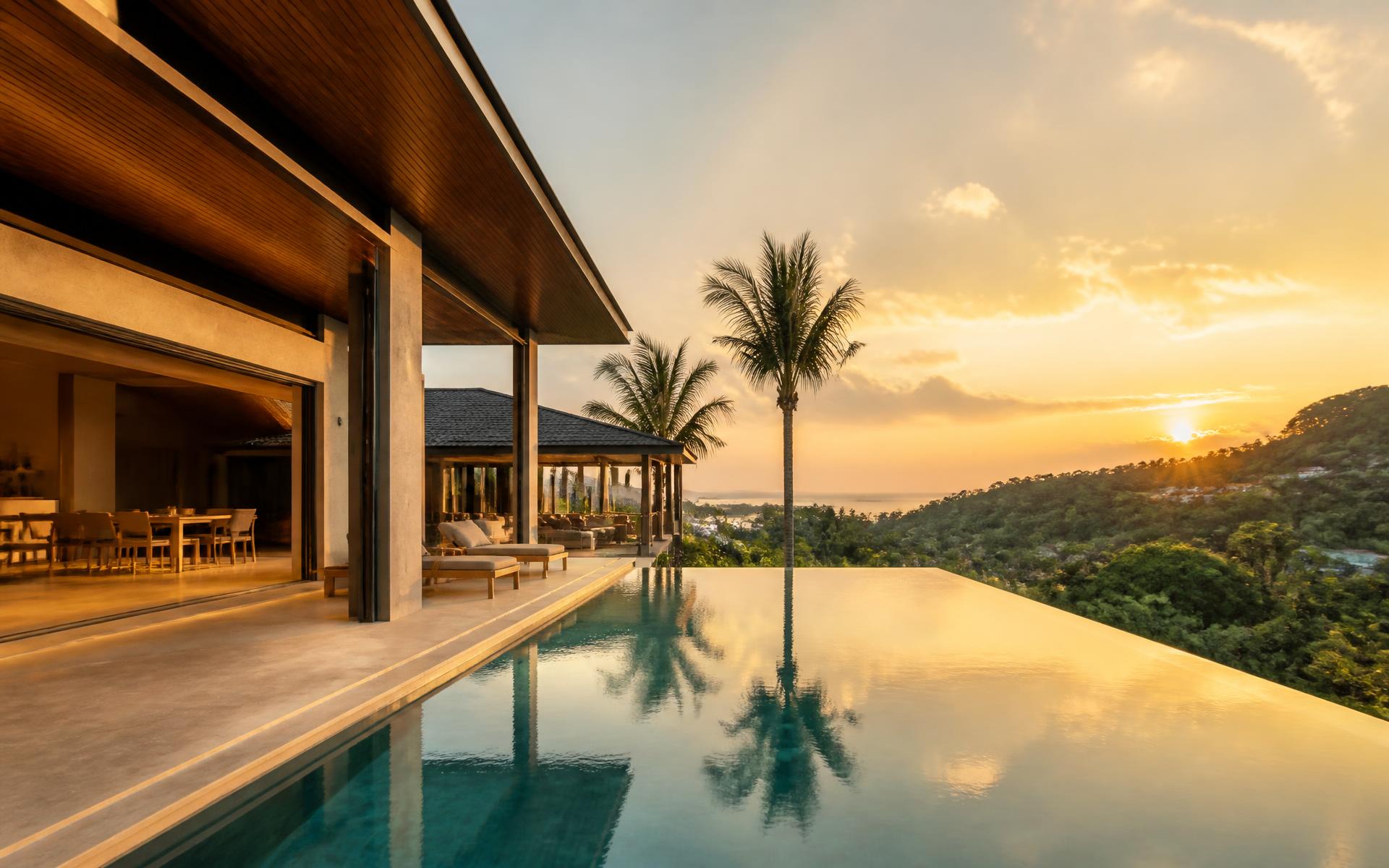 Modern pool villa in Phuket at golden hour overlooking the Andaman coastline